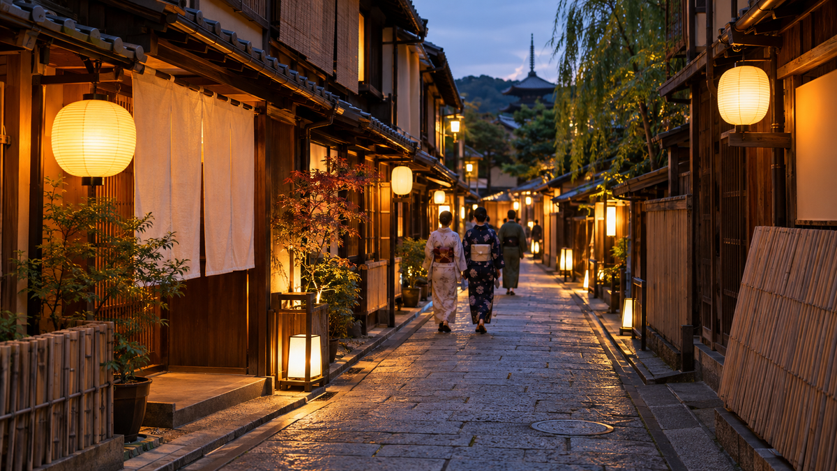 夕暮れの京都の路地に、ちょうちんの明かりがともる料理屋が並ぶ